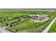 Expansive aerial view of a multi-building property surrounded by lush greenery and agricultural fields at 1614 N Manila Rd, Bennett, CO 80102