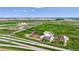 Overhead aerial view of a large property with multiple structures, pens, fields, and roadways at 1614 N Manila Rd, Bennett, CO 80102
