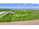 A sprawling property featuring a mix of green fields, infrastructure, and horizon views at 1614 N Manila Rd, Bennett, CO 80102