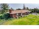 Aerial backyard view with lawn, patio set, and brick exterior at 1614 N Manila Rd, Bennett, CO 80102