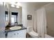 Bathroom featuring a vanity sink, toilet, and shower with white tile at 12831 Mayfair Way # F, Englewood, CO 80112