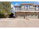 Inviting townhome featuring stone accents, tandem garages, and a charming balcony at 12831 Mayfair Way # F, Englewood, CO 80112