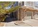 Exterior view of the house featuring stone accents and attached garage at 12831 Mayfair Way # F, Englewood, CO 80112