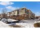 Snow covered townhouse exterior, showcasing architectural details and landscaping at 12831 Mayfair Way # F, Englewood, CO 80112