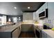 Modern kitchen with white cabinets and quartz countertops at 12831 Mayfair Way # F, Englewood, CO 80112