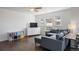 Comfortable living room featuring a large sectional couch and natural light from large windows at 12831 Mayfair Way # F, Englewood, CO 80112