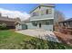 Large backyard with a concrete patio and a small shed behind the house at 381 Tynan Dr, Erie, CO 80516
