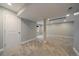 Spacious finished basement with neutral carpet, walls, and a support column at 381 Tynan Dr, Erie, CO 80516