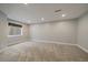 Finished basement space with neutral carpet, paint and a window with blind covering at 381 Tynan Dr, Erie, CO 80516