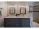 Bathroom featuring a double sink vanity with granite countertops and modern fixtures and lighting at 381 Tynan Dr, Erie, CO 80516