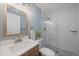Bathroom with modern vanity, glass shower, and neutral tiling at 381 Tynan Dr, Erie, CO 80516