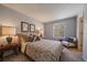 Calm bedroom with large windows and soft natural light. Features a large patterned bed at 381 Tynan Dr, Erie, CO 80516