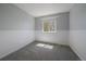 Bright bedroom with a large window, neutral walls, and plush gray carpet at 381 Tynan Dr, Erie, CO 80516