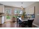 Cozy dining area with modern light fixture, large window, and access to backyard at 381 Tynan Dr, Erie, CO 80516
