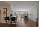 Open-concept dining area with modern lighting, table, and a view of the backyard at 381 Tynan Dr, Erie, CO 80516