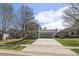 Charming two-story home with a spacious front yard and a long driveway leading to a two-car garage at 381 Tynan Dr, Erie, CO 80516