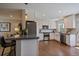 Modern kitchen with stainless steel appliances, white cabinets, and hardwood floors at 381 Tynan Dr, Erie, CO 80516