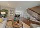 Open concept living area leading to stairs, and kitchen area with hardwood floors at 381 Tynan Dr, Erie, CO 80516