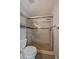 Modern shower with stone pebble base, glass enclosure, and sleek fixtures, next to toilet at 381 Tynan Dr, Erie, CO 80516