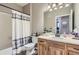 Well-lit bathroom featuring a wooden vanity, neutral tones, and a shower with a striped curtain at 1560 Olympia Cir # 108, Castle Rock, CO 80104