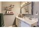 Bright bathroom with white vanity and sink, a large mirror, and floating shelves at 1560 Olympia Cir # 108, Castle Rock, CO 80104