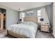 Spacious bedroom featuring soft carpet, bed, two windows, and modern lamps at 1560 Olympia Cir # 108, Castle Rock, CO 80104