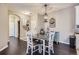 Cozy dining room features dark hardwood floors, modern furnishings, and a decorative chandelier at 1560 Olympia Cir # 108, Castle Rock, CO 80104