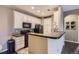 Well-lit kitchen featuring white cabinets, a breakfast bar, and stainless steel appliances at 1560 Olympia Cir # 108, Castle Rock, CO 80104
