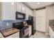 Well-lit kitchen with stainless steel appliances, decorative backsplash, and ample cabinet space at 1560 Olympia Cir # 108, Castle Rock, CO 80104