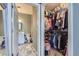 A well-organized walk-in closet with ample hanging space and shelving and a view to the bathroom at 1560 Olympia Cir # 108, Castle Rock, CO 80104