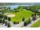 Aerial view of a park with a playground, sports field, and a scenic lake backdrop at 2590 W Long Cir, Littleton, CO 80120