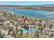 Stunning aerial view highlighting a home near a lake, pool, and tennis courts, offering numerous recreational amenities at 2590 W Long Cir, Littleton, CO 80120