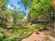 Lush backyard oasis featuring a well-maintained lawn, vibrant garden beds, and stone pathway at 2590 W Long Cir, Littleton, CO 80120
