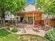 Relaxing backyard featuring a covered deck, patio area, and well-manicured lawn with garden at 2590 W Long Cir, Littleton, CO 80120