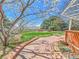 Serene backyard featuring a stone pathway, mature trees, and well-maintained landscaping at 2590 W Long Cir, Littleton, CO 80120