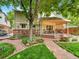 Backyard featuring a covered deck, flagstone patio, mature landscaping and a lush lawn at 2590 W Long Cir, Littleton, CO 80120