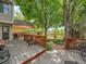 Large backyard featuring a spacious wooden deck, and lush landscaping with a garden area at 2590 W Long Cir, Littleton, CO 80120