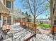 Backyard deck with lake view features a pergola, outdoor seating, and landscaped garden at 2590 W Long Cir, Littleton, CO 80120