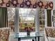 Scenic backyard view through a window with a table and chairs on an outdoor patio at 2590 W Long Cir, Littleton, CO 80120