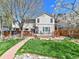 Expansive backyard with a well-manicured lawn, wooden deck, and a charming stone pathway at 2590 W Long Cir, Littleton, CO 80120
