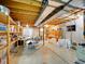 Unfinished basement space with exposed wood beams, shelving, and concrete floors at 2590 W Long Cir, Littleton, CO 80120