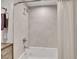Well-lit bathroom showcasing a white tub and shower combo with modern tile and sleek fixtures at 2590 W Long Cir, Littleton, CO 80120