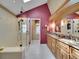 Elegant bathroom featuring double vanity, marble countertops, and glass shower with bench at 2590 W Long Cir, Littleton, CO 80120