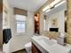 Modern bathroom with a decorative tile wall, contemporary fixtures, and a sleek vanity at 2590 W Long Cir, Littleton, CO 80120