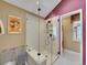 Bathroom featuring a large walk-in shower with a glass enclosure and a bench at 2590 W Long Cir, Littleton, CO 80120