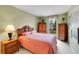 Cozy bedroom with charming wooden furniture, a floral window treatment, and natural light at 2590 W Long Cir, Littleton, CO 80120