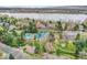 Aerial view features a community pool, tennis courts, and playground near residential homes at 2590 W Long Cir, Littleton, CO 80120