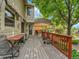 A spacious outdoor deck features wooden flooring, a comfortable seating area, and lush green surroundings at 2590 W Long Cir, Littleton, CO 80120