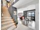Grand entryway featuring a staircase, open floor plan, and views of the dining and living areas at 2590 W Long Cir, Littleton, CO 80120