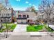 Charming two-story home with a well-manicured front lawn and a three car garage at 2590 W Long Cir, Littleton, CO 80120